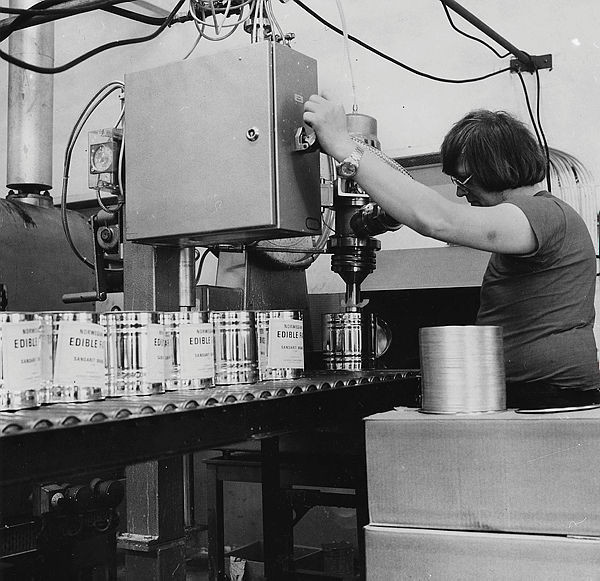 Thorbjørn Hoverud fyller spann med fett til Norad.  Norad er direktoratet for utviklingssamarbeid.